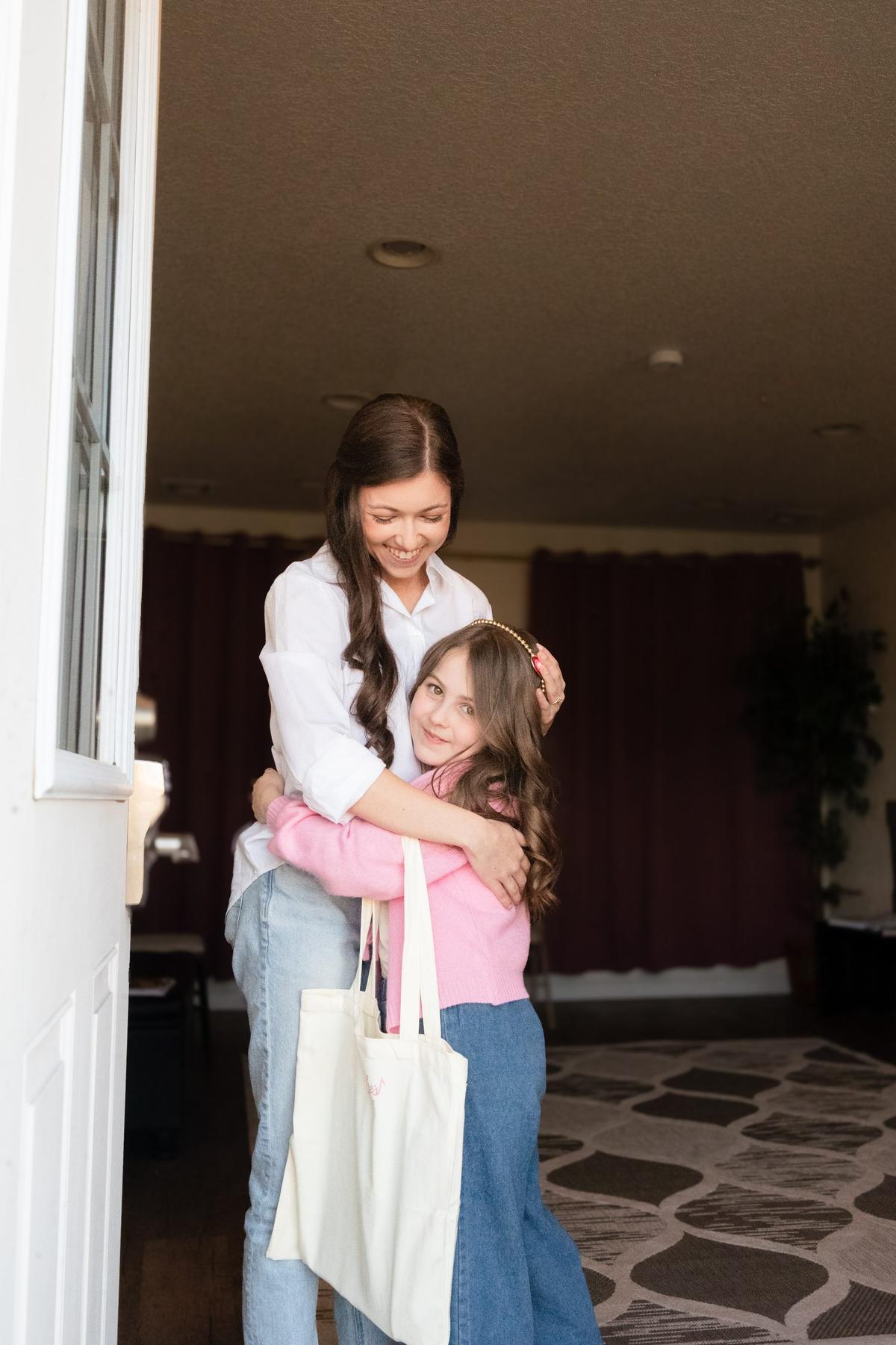 Baylee welcoming a student at the door